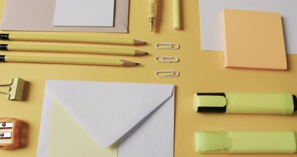Desk with stationery, pen, and paper neatly arranged